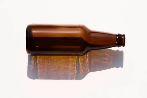 Close up view of empty glass bottle on white tabletop — Stock Photo