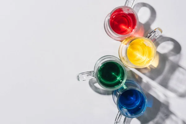 Top view of alcohol cocktails in glasses on white tabletop — Stock Photo