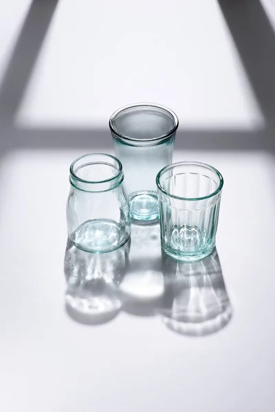 Close up view of empty glassware on white surface — Stock Photo