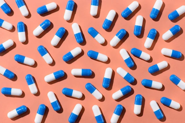 Top view of pills on orange tabletop — Stock Photo