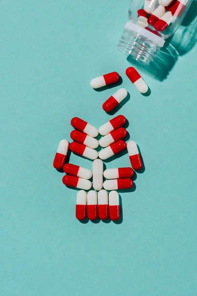 Top view of skull made of drug capsules on blue — Stock Photo