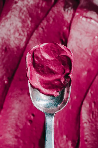 Top view of spoon with tasty appetizing pink dessert — Stock Photo