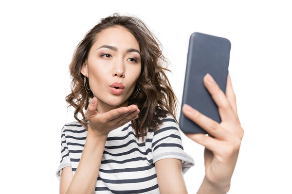 woman taking selfie on smartphone