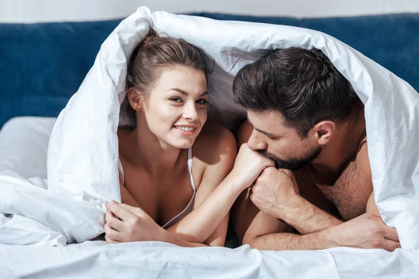 Happy couple under blanket — Stock Photo, Image