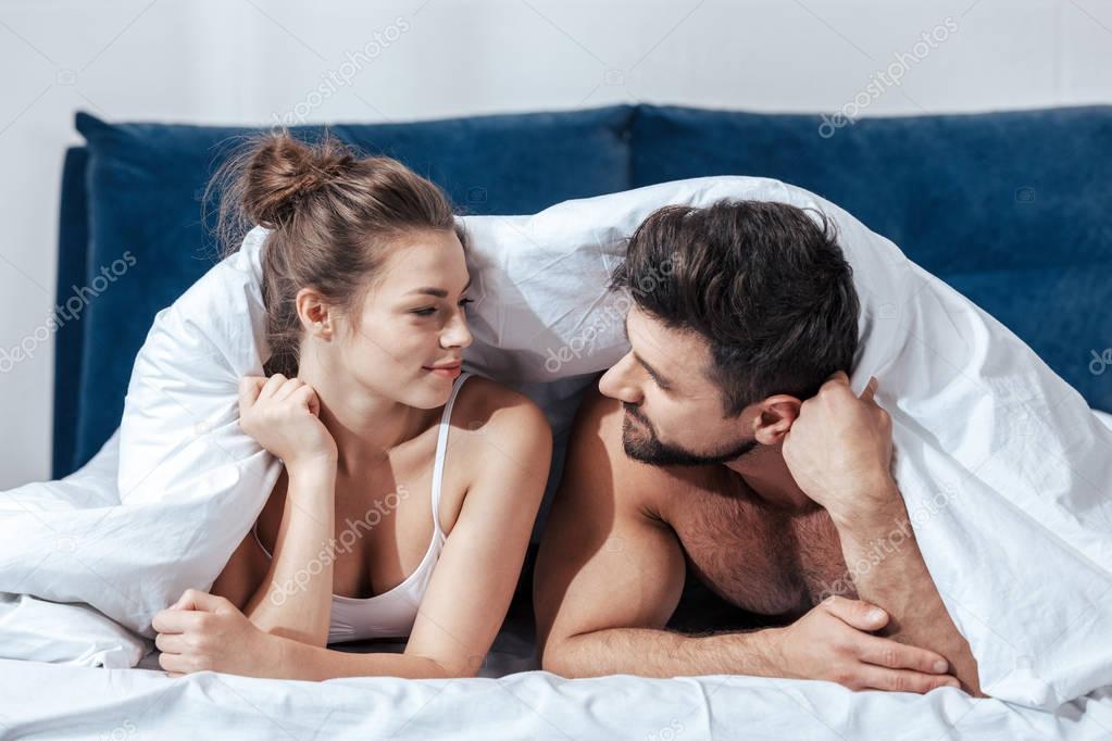 happy couple under blanket