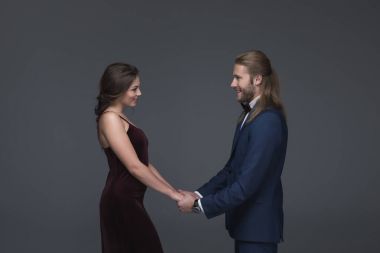 sweethearts in evening outfit holding hands