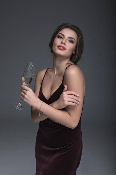young lady holding glass of champagne