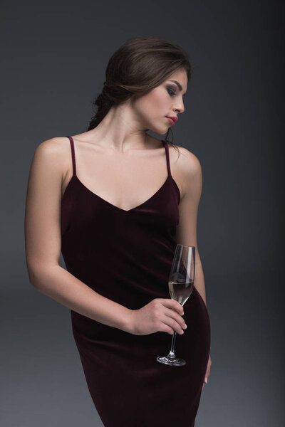 young lady holding glass of champagne