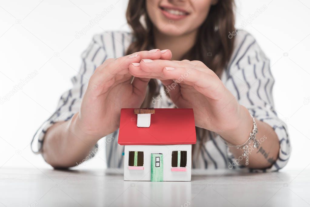 Young woman with house model 