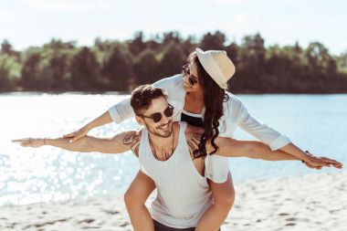 Happy young couple at beach  clipart