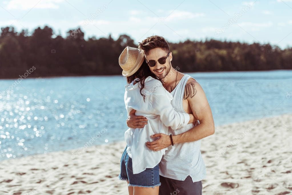 Happy young couple at beach 