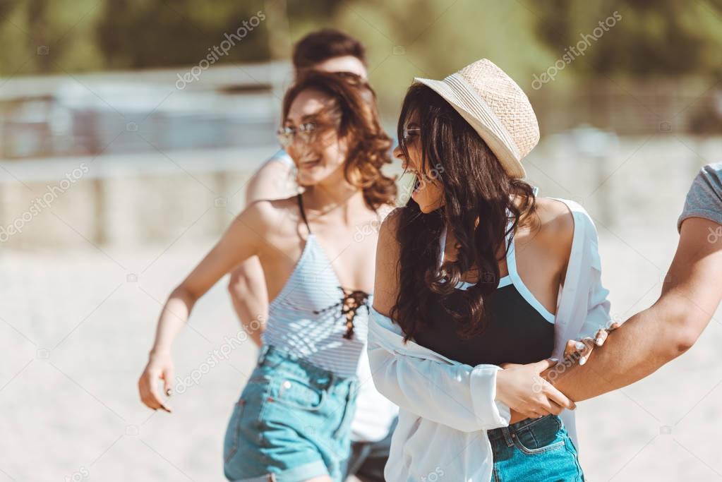 Friends walking at beach 