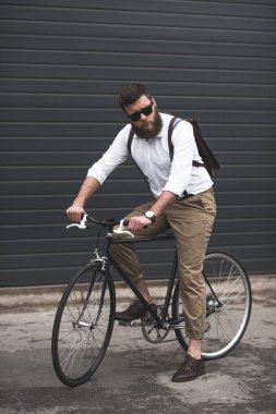 stylish man riding bicycle clipart