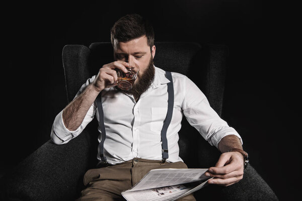 man with whisky and newspaper