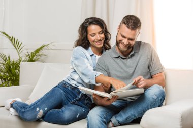 couple looking at photo album clipart