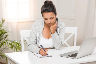 woman writing in notebook clipart