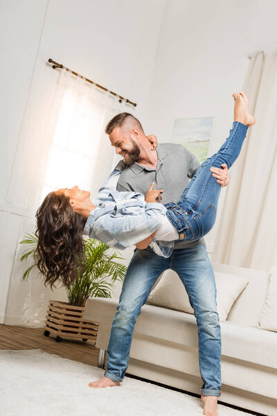 man holding woman in his arms