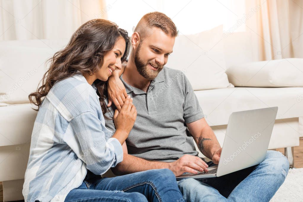 couple using laptop