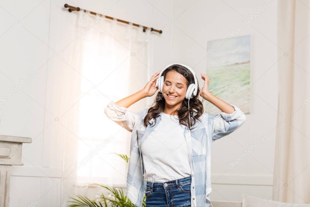 Woman listening music in headphones 