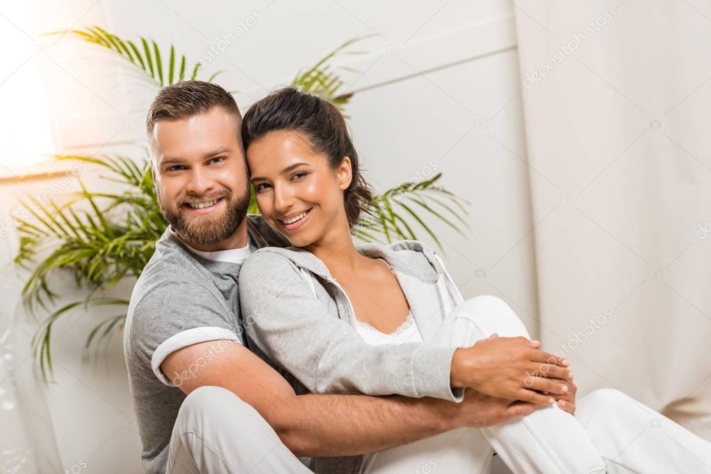 man hugging woman