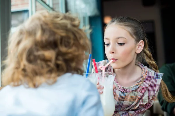 Adorable kids drinking milkshake — Stock Photo, Image