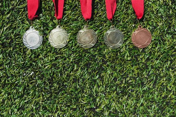 Various medals on grass — Stock Photo, Image