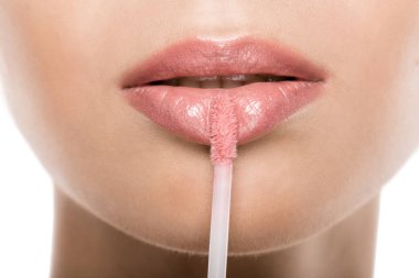 woman applying lipgloss clipart