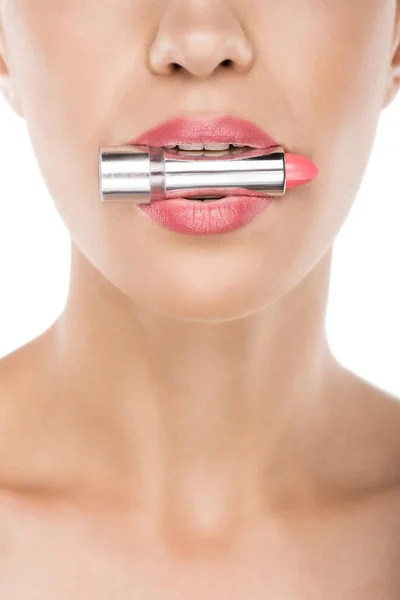 Woman holding lipstick in mouth — Stock Photo, Image