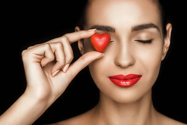 Woman with heart shaped candy — Stock Photo, Image