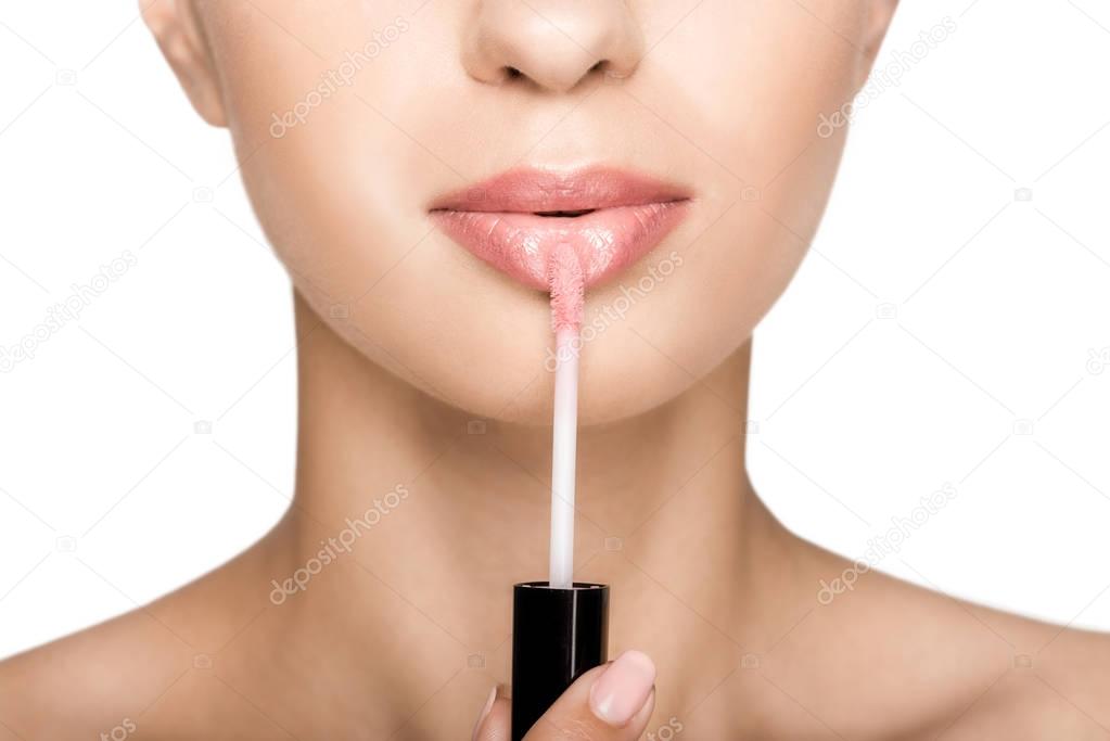 woman applying lipgloss