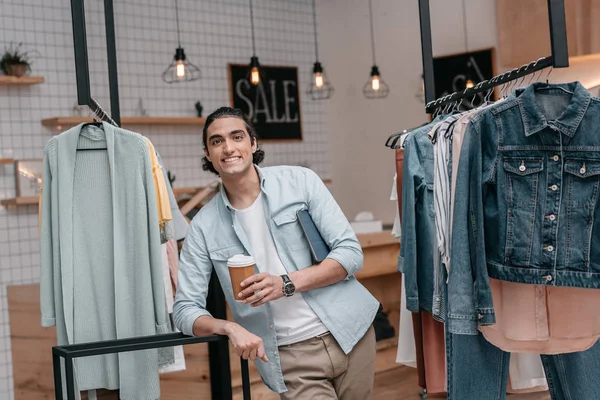 Shop owner drinking coffee — Stock Photo, Image