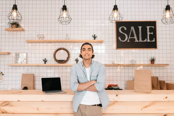 Confident young man in store — Stock Photo, Image