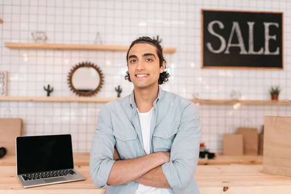 Confident young man in store — Stock Photo, Image