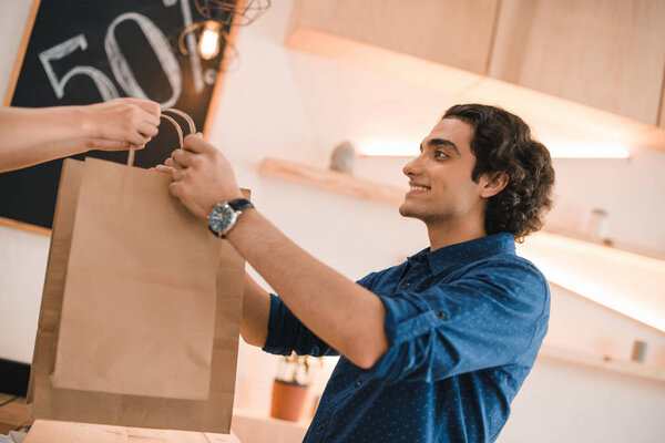 seller giving shopping bags to client