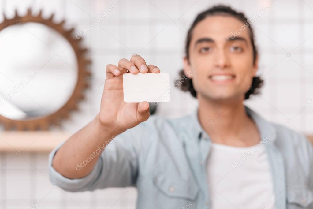 man showing business card