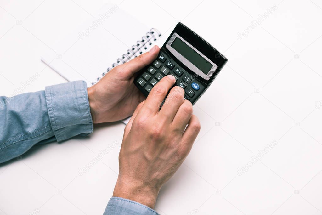 hands with calculator and notepad