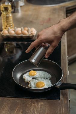 Kahvaltı için yumurta hazırlarken adam