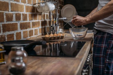 Kahvaltı için yumurta hazırlarken adam