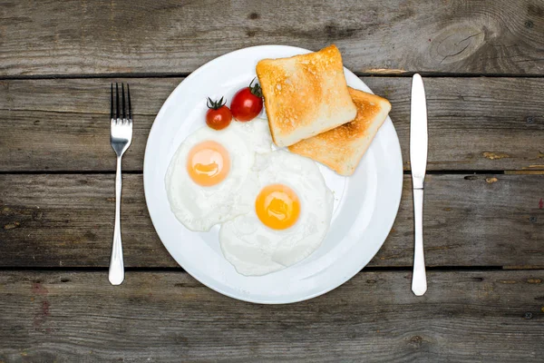 Fried eggs and toasts on plate — Stock Photo, Image