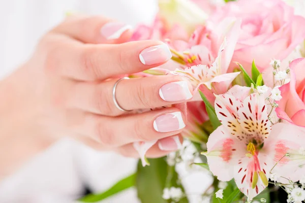 Main féminine avec des fleurs — Photo