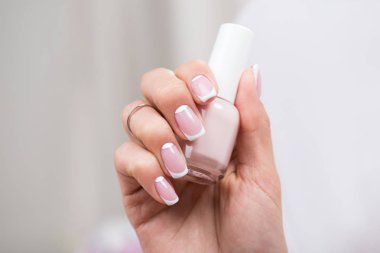 woman holding nail polish