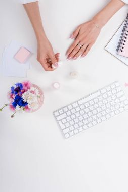 woman doing manicure at workplace  clipart