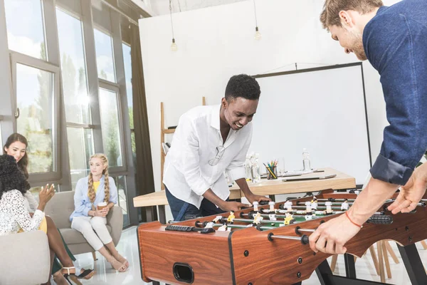 Multicultural businessmen playing table football — Stock Photo, Image