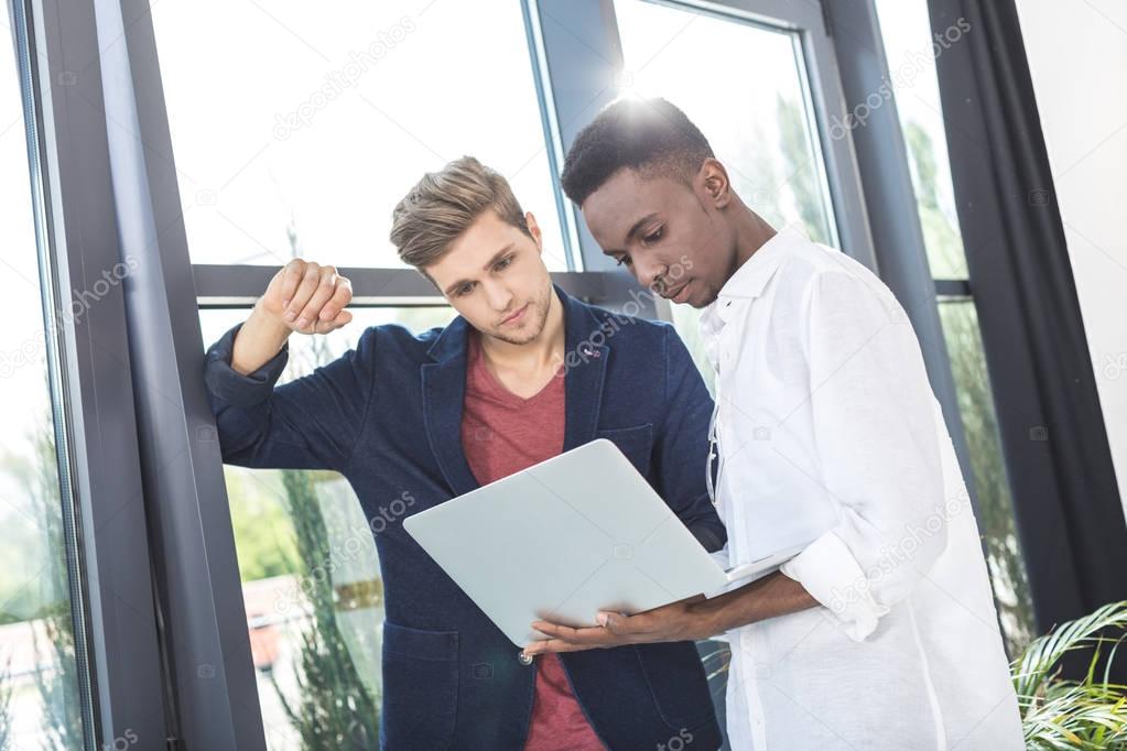 multicultural businessmen working on laptop