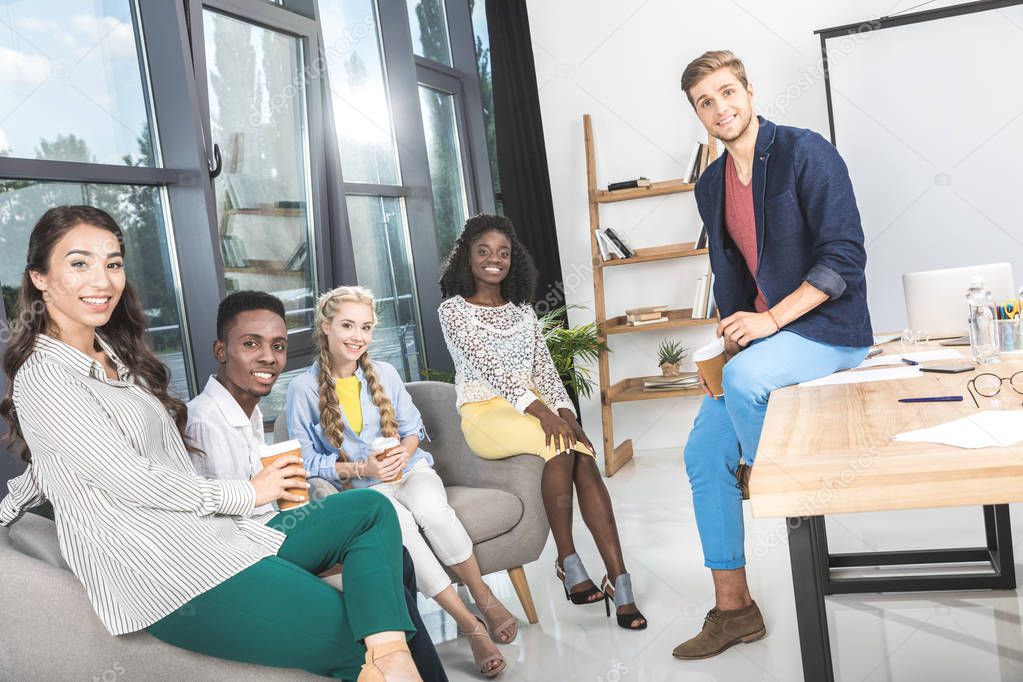 multiethnic coworkers having coffee break