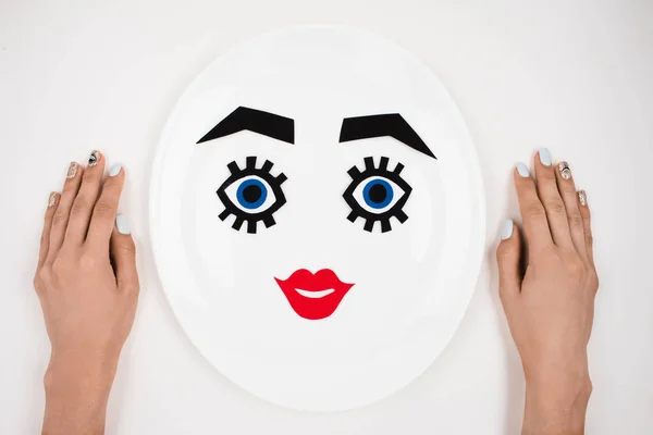 Paper face with makeup on plate — Stock Photo, Image