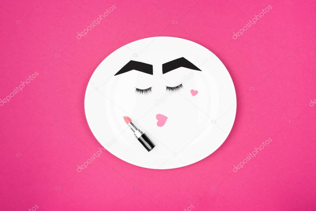 paper face with makeup on plate 