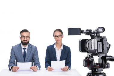 newscasters sitting in front of camera clipart