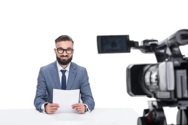 Newscaster sitting in front of camera — Free Stock Photo