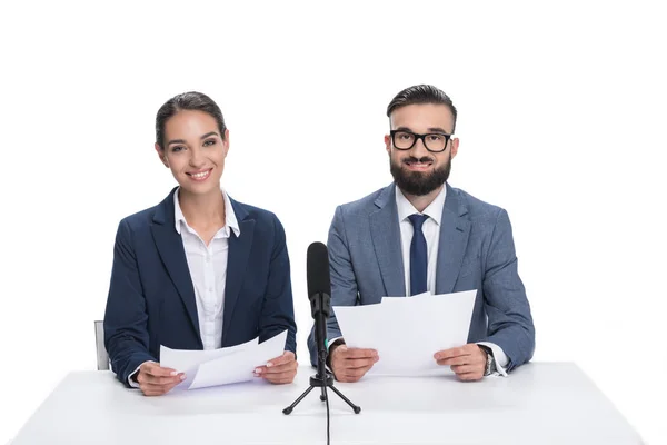 Newscasters with papers and microphone — Stock Photo, Image